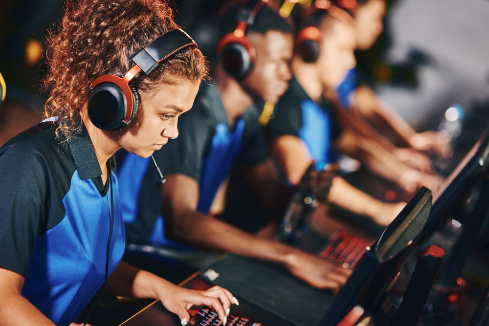 Focused female cybersport gamer wearing headphones.